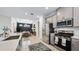 Modern kitchen with stainless steel appliances, light gray cabinets, and a spacious island overlooking the dining area at 29477 Velletri Ln, Wesley Chapel, FL 33543