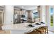 Bright kitchen featuring modern appliances, stylish cabinets, quartz countertops and an island with bar stool seating at 29477 Velletri Ln, Wesley Chapel, FL 33543