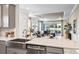 Open kitchen with gray cabinets, stainless steel appliances, and a view into the adjacent living area with access to the patio at 29477 Velletri Ln, Wesley Chapel, FL 33543