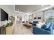 Open concept living space featuring a cozy seating area, tray ceiling, and seamless flow to the kitchen at 29477 Velletri Ln, Wesley Chapel, FL 33543