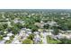 An aerial shot showcases a mix of homes and community buildings nestled among lush greenery and peaceful streetscapes at 2955 Briar Cliff Dr, Palm Harbor, FL 34684