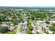 A charming neighborhood showcases residential homes with lush greenery, a pond, and well-maintained streets at 2955 Briar Cliff Dr, Palm Harbor, FL 34684