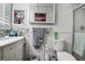 Bathroom featuring white vanity, mosaic tile accents, and a glass enclosed shower at 2955 Briar Cliff Dr, Palm Harbor, FL 34684
