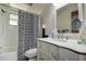 The bathroom features a vanity with a bird design, a large mirror, and a shower with a zebra-print curtain at 2955 Briar Cliff Dr, Palm Harbor, FL 34684