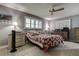 Cozy bedroom with a ceiling fan, plantation shutters, and ample natural light at 2955 Briar Cliff Dr, Palm Harbor, FL 34684