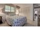 Bright bedroom features a bed with starfish-patterned bedding, tile floor and closet at 2955 Briar Cliff Dr, Palm Harbor, FL 34684
