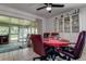 Casual dining area near enclosed porch with ceiling fan and display cabinet at 2955 Briar Cliff Dr, Palm Harbor, FL 34684
