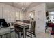 Elegant dining area with modern lighting, stylish furniture, and access to the kitchen, ideal for Gathering meals and gatherings at 2955 Briar Cliff Dr, Palm Harbor, FL 34684