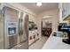 Bright kitchen featuring stainless steel appliances and an open view into dining area at 2955 Briar Cliff Dr, Palm Harbor, FL 34684