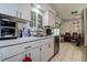 Functional kitchen with white countertops and cabinets with an eating area nearby at 2955 Briar Cliff Dr, Palm Harbor, FL 34684