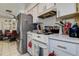 Kitchen featuring white appliances and countertops with an adjacent dining space at 2955 Briar Cliff Dr, Palm Harbor, FL 34684