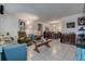 Open-concept living space with tile floors, comfortable furnishings, and seamless flow to the dining area at 2955 Briar Cliff Dr, Palm Harbor, FL 34684