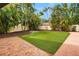 Lush backyard with artificial turf, vibrant landscaping, and a charming outdoor ambiance at 326 16Th Ne Ave, St Petersburg, FL 33704