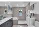 Elegant bathroom showcasing gray tile, a tub, a walk-in shower, and modern fixtures at 326 16Th Ne Ave, St Petersburg, FL 33704