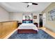 Cozy bedroom with a comfortable bed, blue rug, wooden cabinets, and an ensuite bathroom at 326 16Th Ne Ave, St Petersburg, FL 33704