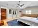Bright bedroom featuring a large bed, ceiling fan, natural light, built-in storage, and wood-look flooring at 326 16Th Ne Ave, St Petersburg, FL 33704