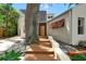 Stunning home with an inviting front door and beautifully landscaped entrance surrounded by rocks and greenery at 326 16Th Ne Ave, St Petersburg, FL 33704