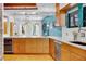 Sunlit kitchen showcases wood cabinetry, granite counters, a beverage cooler, stainless appliances and views to the dining area at 326 16Th Ne Ave, St Petersburg, FL 33704