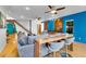 Bright, stylish living room with hardwood floors, ceiling fans, bar, and modern blue accent wall at 326 16Th Ne Ave, St Petersburg, FL 33704