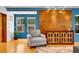 Comfortable living room featuring hardwood floors, a grey armchair, and a wooden cabinet at 326 16Th Ne Ave, St Petersburg, FL 33704