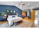 Spacious main bedroom with a large bed, blue accent wall, and a walk-in closet at 326 16Th Ne Ave, St Petersburg, FL 33704