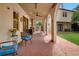 Charming covered patio with ceiling fan, brick flooring, archways, and comfortable outdoor seating at 326 16Th Ne Ave, St Petersburg, FL 33704