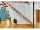 View of the modern staircase with wood steps, metal railings, and geometric wall design at 326 16Th Ne Ave, St Petersburg, FL 33704