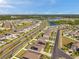 Vibrant community featuring well-maintained homes, lush landscaping, and solar panels under a clear, blue sky with cityscape in background at 4201 Globe Thistle Dr, Tampa, FL 33619