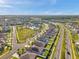 Wide aerial view of a modern neighborhood featuring solar panels, green common areas, a community pool, and well-maintained streets at 4201 Globe Thistle Dr, Tampa, FL 33619