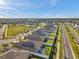 Aerial shot showcasing a residential community with solar panels, lush green spaces, and a pool, all under a sunny blue sky at 4201 Globe Thistle Dr, Tampa, FL 33619