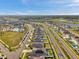 Beautiful aerial view of a residential community with a pool, lake, and well-maintained streets at 4201 Globe Thistle Dr, Tampa, FL 33619