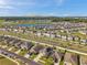 Areal view of neighborhood with a lake and some homes with solar panels and fenced yards at 4201 Globe Thistle Dr, Tampa, FL 33619