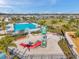 Community splash pad and pool with palm trees and lounge chairs at 4201 Globe Thistle Dr, Tampa, FL 33619