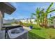 Landscaped backyard with green grass, tropical banana plants, and an air conditioner, perfect for relaxation at 4201 Globe Thistle Dr, Tampa, FL 33619