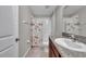 Well-lit bathroom with granite countertops, a vanity, and a shower featuring a Paris-themed curtain at 4201 Globe Thistle Dr, Tampa, FL 33619