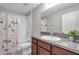 Cozy bathroom featuring a granite vanity, white sink, toilet, and shower-tub combo at 4201 Globe Thistle Dr, Tampa, FL 33619