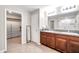 Bathroom features a double sink vanity with granite countertops, tile floor and a large closet at 4201 Globe Thistle Dr, Tampa, FL 33619