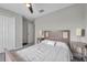 Bedroom featuring a ceiling fan, closet, and ensuite bathroom at 4201 Globe Thistle Dr, Tampa, FL 33619