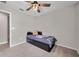 A cozy bedroom with a ceiling fan and bed dressed with a patterned blanket at 4201 Globe Thistle Dr, Tampa, FL 33619