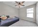 Charming bedroom with a ceiling fan and a bright window, offering a comfortable retreat at 4201 Globe Thistle Dr, Tampa, FL 33619