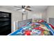 Bedroom featuring a bunk bed, shelves, ceiling fan, and carpeted floor at 4201 Globe Thistle Dr, Tampa, FL 33619