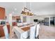 Open concept dining area features stylish light fixture, seating for six, and views of the kitchen and living room at 4201 Globe Thistle Dr, Tampa, FL 33619