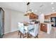 Dining area with seating for six featuring modern light fixture above table and views of kitchen at 4201 Globe Thistle Dr, Tampa, FL 33619