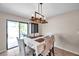 Bright dining area with sliding glass doors, a modern light fixture, and a neutral color palette at 4201 Globe Thistle Dr, Tampa, FL 33619