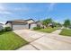 Exterior shot of home featuring a well-manicured lawn, driveway and welcoming curb appeal at 4201 Globe Thistle Dr, Tampa, FL 33619