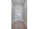 Bright foyer featuring tile flooring and a neutral-colored interior door at 4201 Globe Thistle Dr, Tampa, FL 33619