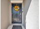 Welcoming front door adorned with a vibrant sunflower wreath, enhancing curb appeal at 4201 Globe Thistle Dr, Tampa, FL 33619