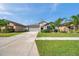 Exterior shot of home with a well-manicured lawn and inviting curb appeal on a sunny day at 4201 Globe Thistle Dr, Tampa, FL 33619