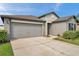Home exterior featuring a spacious two-car garage and well-maintained landscaping at 4201 Globe Thistle Dr, Tampa, FL 33619