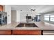 View of the kitchen island featuring granite countertops and stainless steel sink, and views of the living room at 4201 Globe Thistle Dr, Tampa, FL 33619